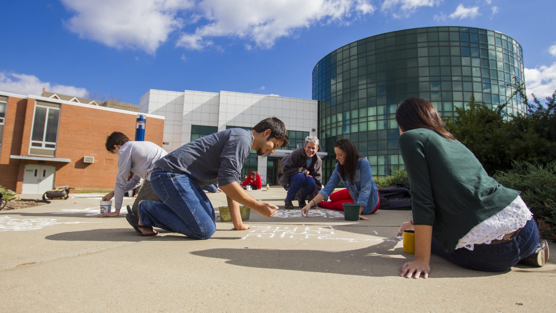 Students chalking sidewalks outside the School of Fine arts.